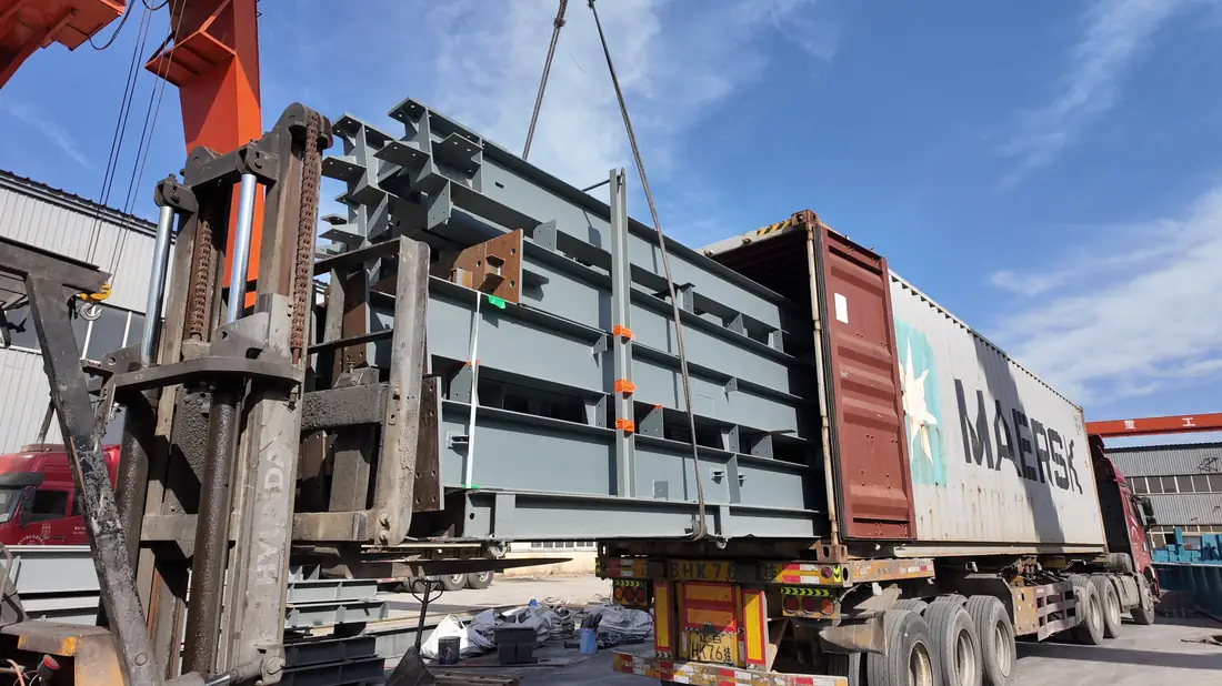 Steel bundle lifted into a shipping container at the factory